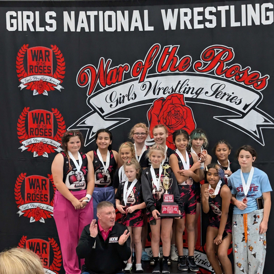 A team on the podium with their trophy at War of the Roses