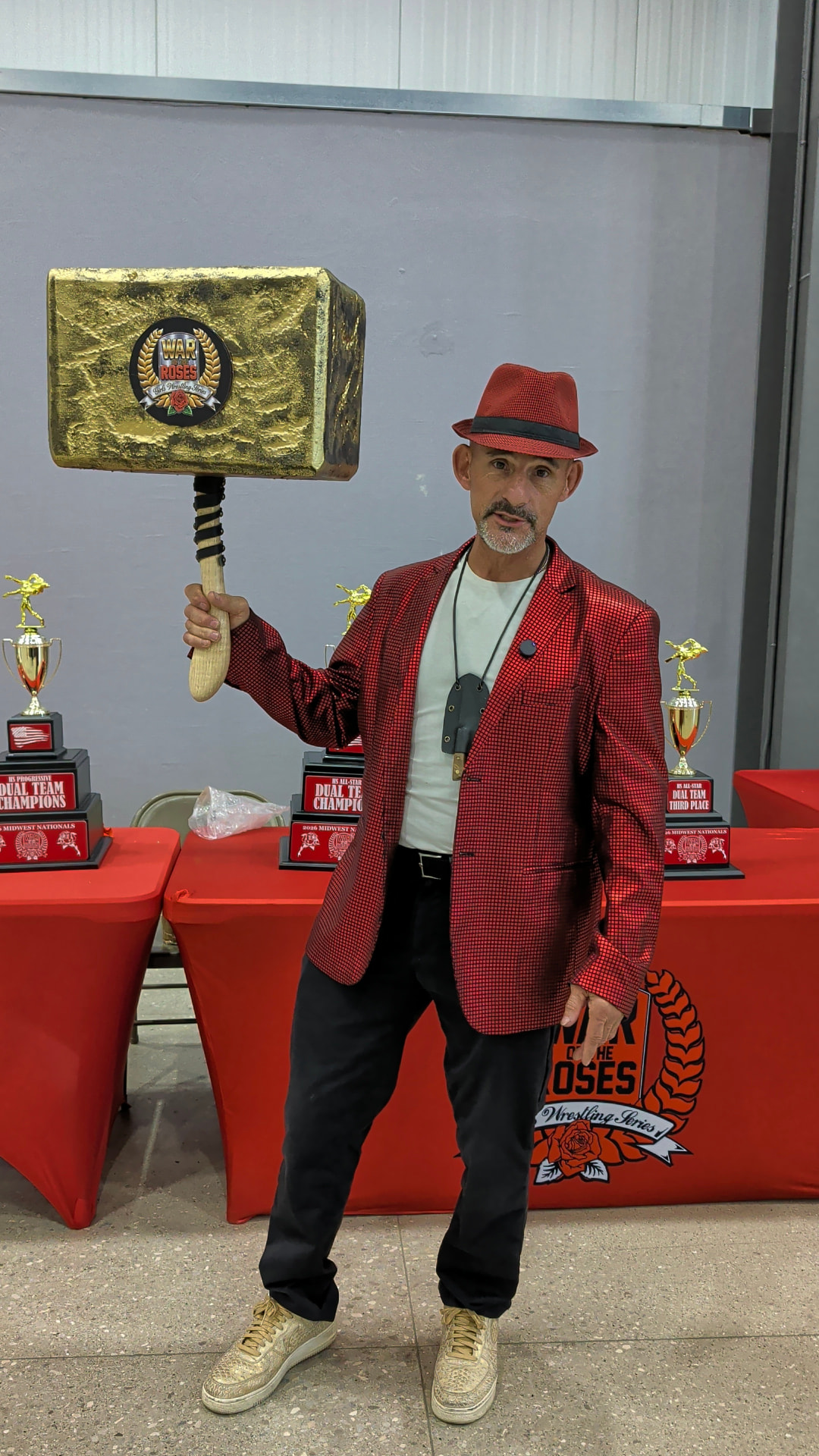 Jason DeLois holding the gold Harvey’s Hammer award