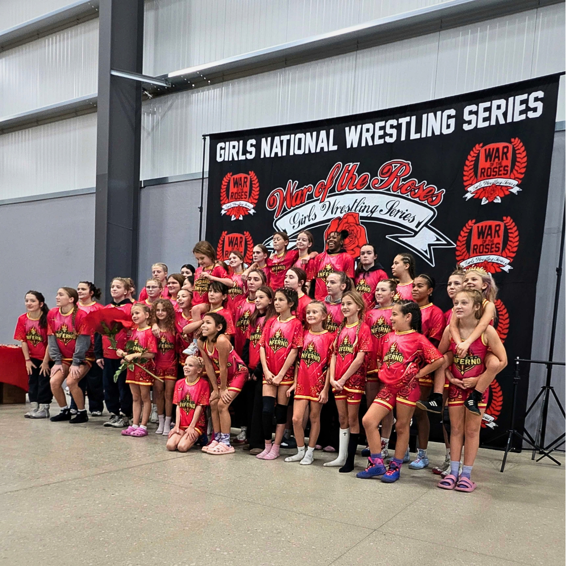 A full team in red in front of the War of the Roses banner